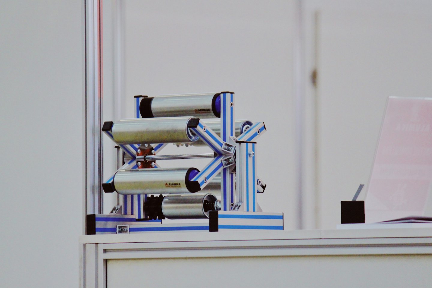 Alumka-Industriemaschine mit silbernen Rollen auf einem Tisch.