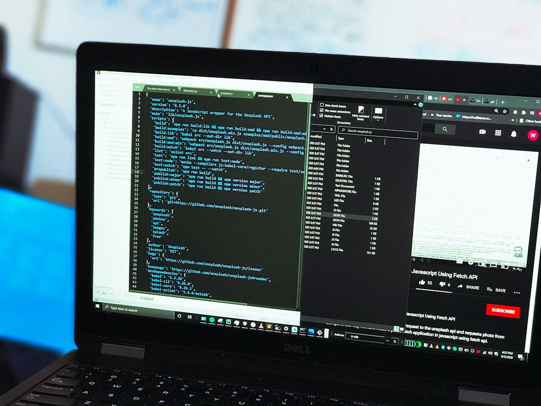 Open laptop screen displaying code editor and tutorial video.