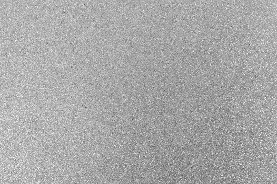 Uniform light grey surface with a fine grainy texture.