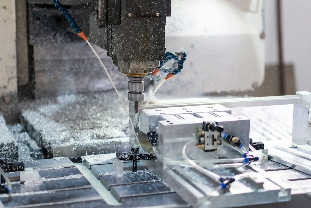 CNC milling machine cutting metal workpiece with coolant.