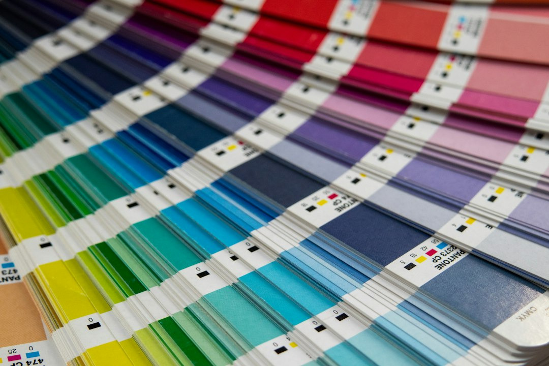 Pantone color swatch book fanned out displaying bright colors.
